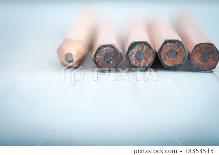 Old pencil on a light blue wooden desk 18353513