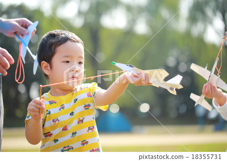 Child to skip paper airplane 18355731