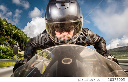 Biker racing on the road Biker racing on the road 18372005