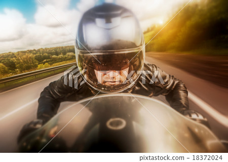 Biker racing on the road Biker racing on the road 18372024