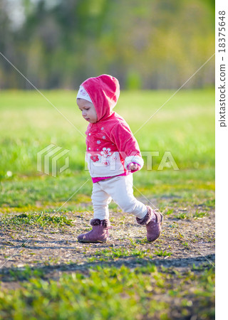Happy little girl walking in the meadow and Happy little girl walking in the meadow and 18375648