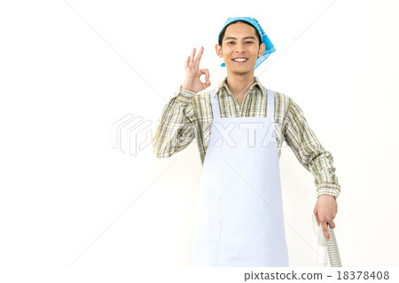 A young man cleaning a vacuum cleaner image A young man cleaning a vacuum cleaner image 18378408