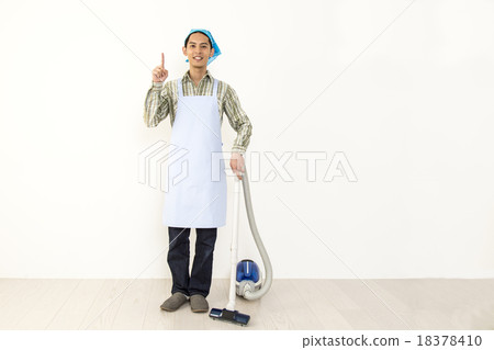 A young man cleaning a vacuum cleaner image 18378410