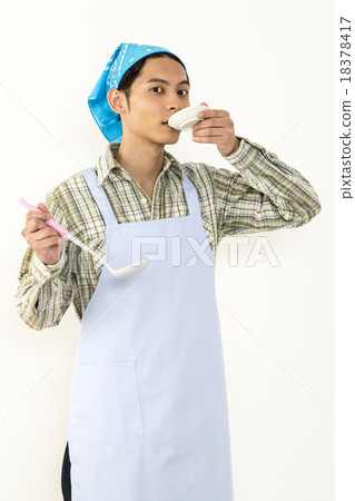 A young man tasting with a small dish image A young man tasting with a small dish image 18378417