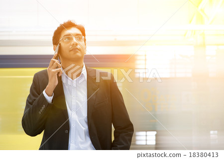 Indian businessman on the phone at railway station. 18380413