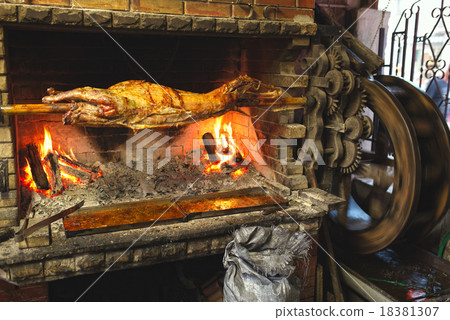 Barbecue (BBQ) Hulks of pork on a spit a grill Barbecue (BBQ) Hulks of pork on a spit a grill 18381307