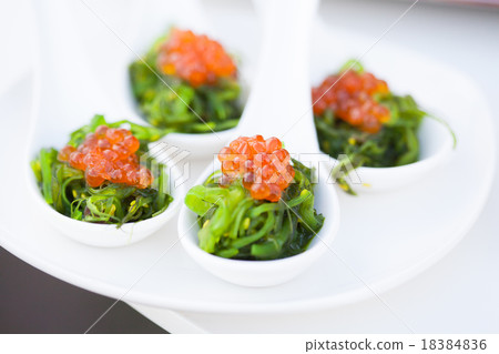 red caviar close-up in white spoons on banquet 18384836