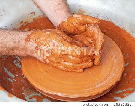 Potter hands taken closeup on pottery wheel. 18385322