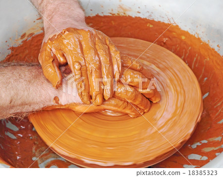Potter hands taken closeup on pottery wheel. 18385323