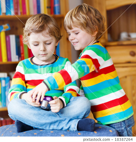 Two little siblings kid boys  making photos  18387264