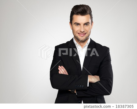Portrait of smiling businessman in black suit 18387305