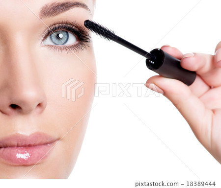 woman applying mascara on eyelashes 18389444