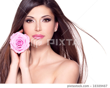 beautiful pretty woman with long hair and pink rose at face. beautiful pretty woman with long hair and pink rose at face. 18389487