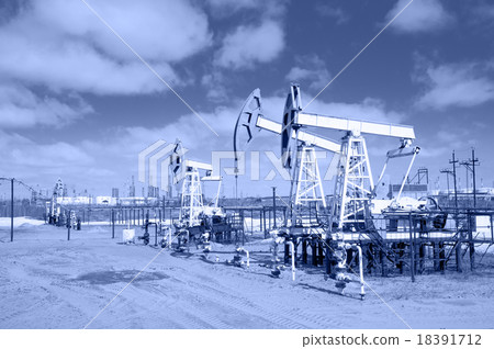 Pump jack on a oilfield. Toned. 18391712