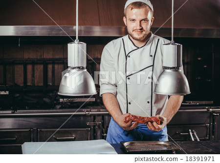 young cook in restaurant kitchen 18391971