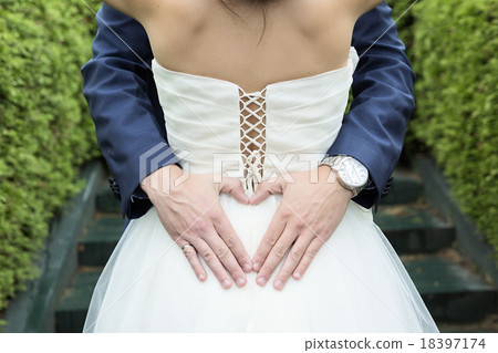 Heart shape hands of groom around bride at wedding Heart shape hands of groom around bride at wedding 18397174