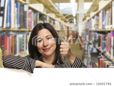 Hispanic Woman with Thumbs Up On White Board in Library Hispanic Woman with Thumbs Up On White Board in Library 18401746