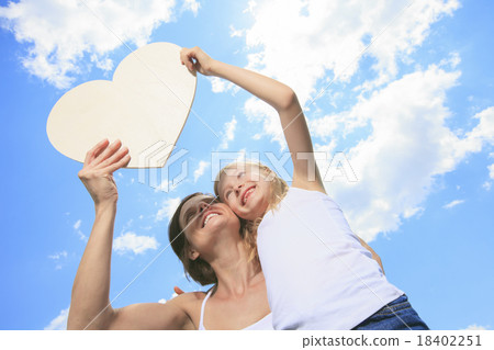 loving mother and daughter, holding a heart shaped 18402251