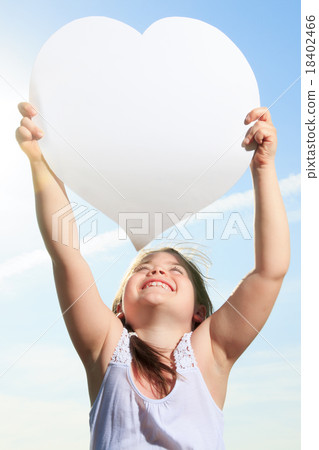 young child holding heart over the sky young child holding heart over the sky 18402466