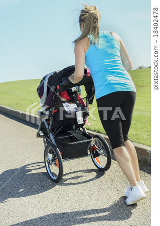 A mother training with baby on a summer day 18402478