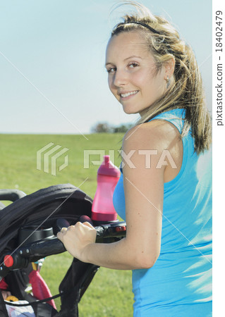 A mother training with baby on a summer day A mother training with baby on a summer day 18402479