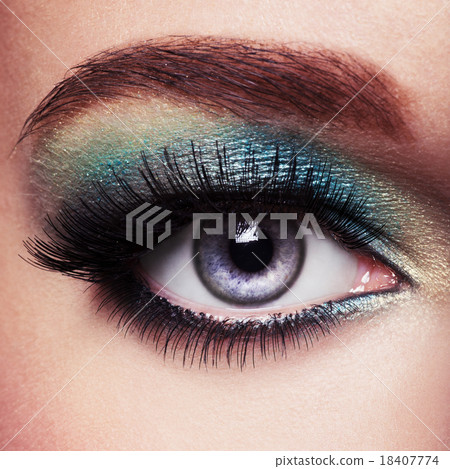 Woman's eye with green eye make-up. Long eyelashes Woman's eye with green eye make-up. Long eyelashes 18407774