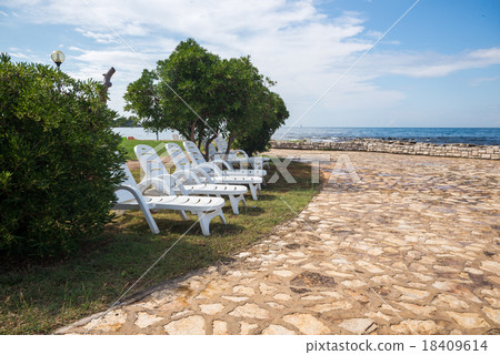 loungers on the rocky beach loungers on the rocky beach 18409614