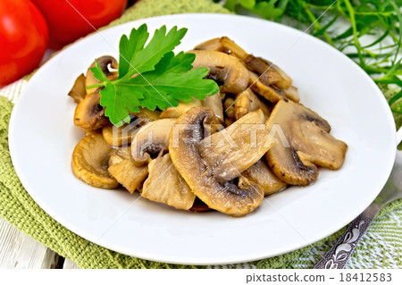 Champignons fried in plate and tomatoes Champignons fried in plate and tomatoes 18412583