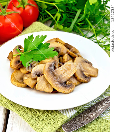 Champignons fried in plate with fork Champignons fried in plate with fork 18412584