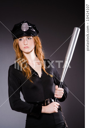 Woman police office in dark room Woman police office in dark room 18414107