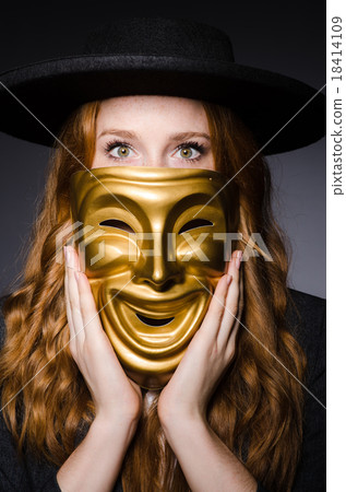 Woman with mask in hypocrisy concept Woman with mask in hypocrisy concept 18414109