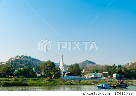 Boat on Irrawaddy river with Pagoda and village 18415758