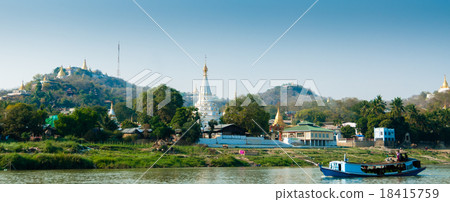 Boat on Irrawaddy river with Pagoda and village 18415759