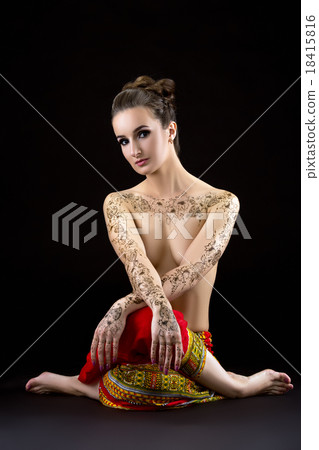 Topless woman with mehendi on chest and shoulders 18415816