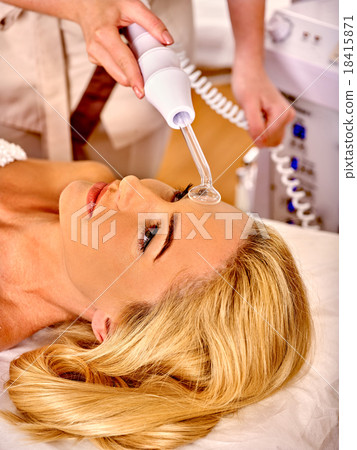 Young woman receiving darsonval facial massage. 18415871