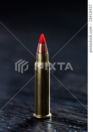 Small-caliber tracer cartridges on a dark 18418437