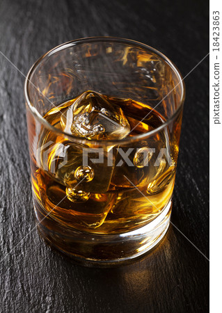 Glass of scotch whiskey with ice 18423863