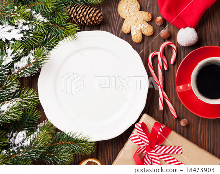 Christmas tree branch, empty plate and coffee Christmas tree branch, empty plate and coffee 18423903