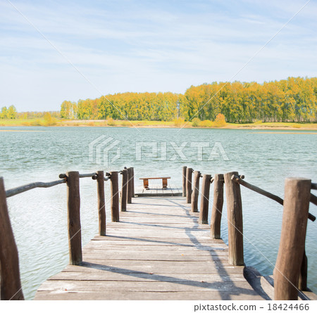 Wooden footbridge over the water 18424466
