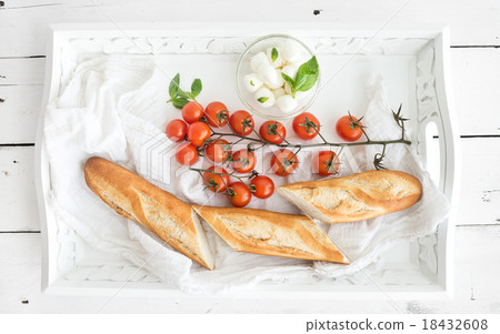 Baguette with branch of cherry-tomatoes, basil and Baguette with branch of cherry-tomatoes, basil and 18432608