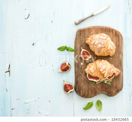 Freshly baked croissants with fresh figs and 18432665