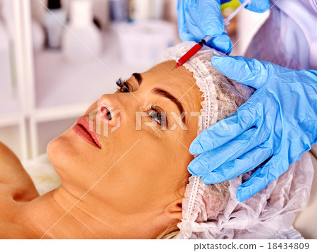 Woman middle-aged in spa salon with beautician 18434809