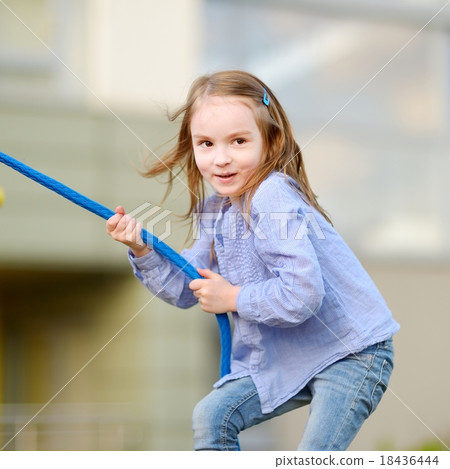 Little preschooler girl having fun with a rope Little preschooler girl having fun with a rope 18436444