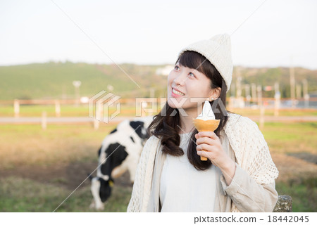 A woman eating a soft cream 18442045