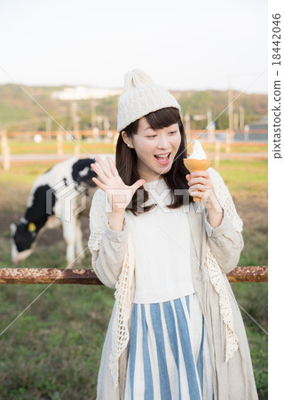 A woman eating a soft cream 18442046