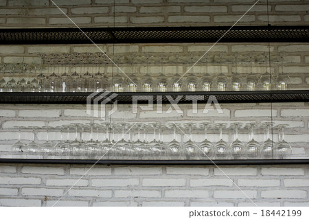 Empty glasses for wine above a bar rack 18442199