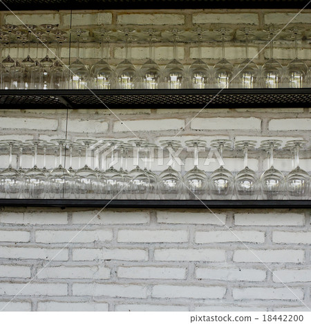 Empty glasses for wine above a bar rack Empty glasses for wine above a bar rack 18442200