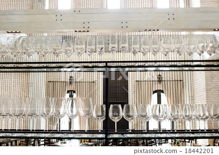 Empty glasses for wine above a bar rack 18442201