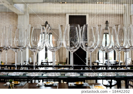 Empty glasses for wine above a bar rack Empty glasses for wine above a bar rack 18442202