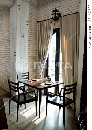 Restaurant tables near the bright window 18442203